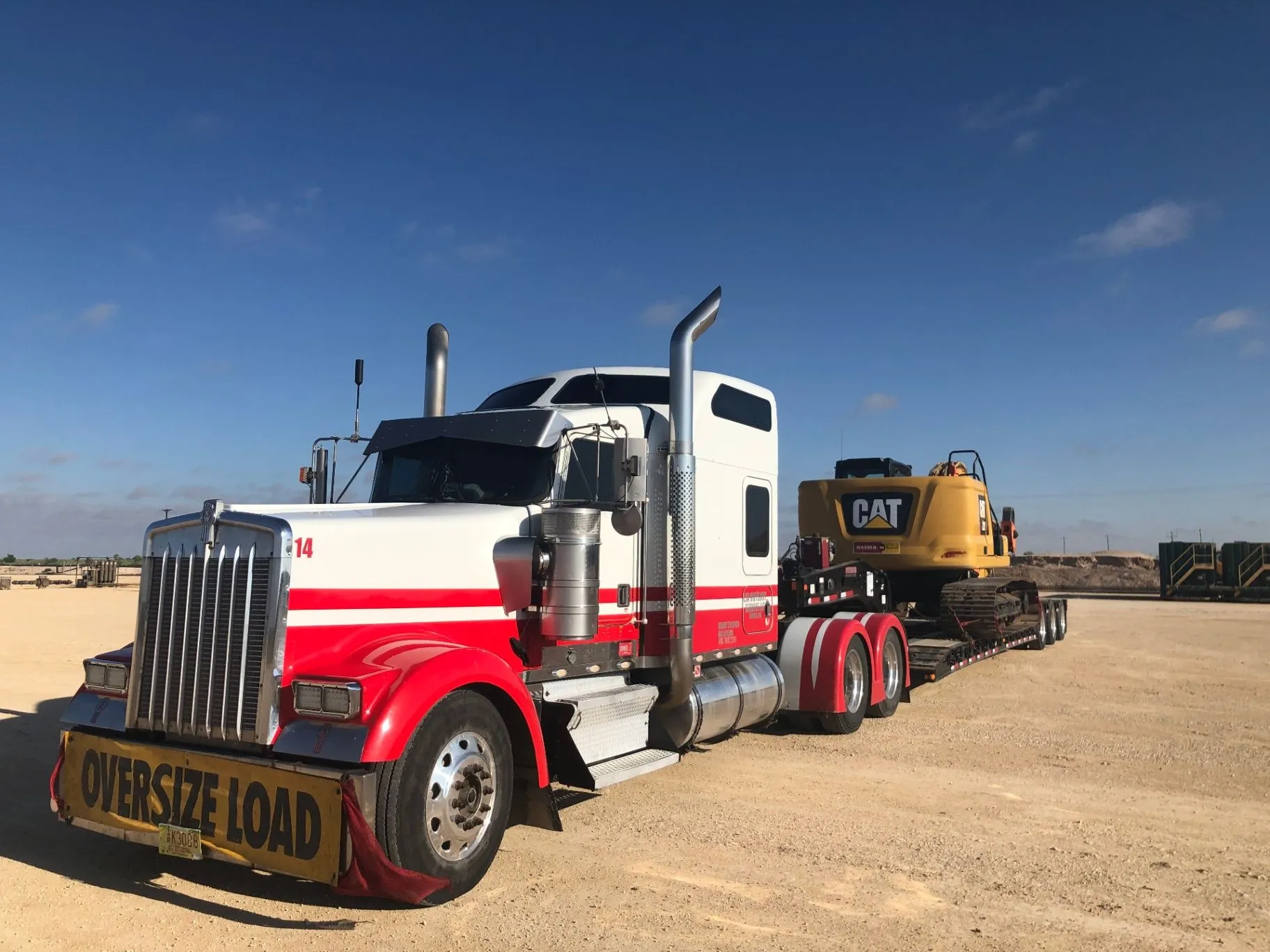 LJA Solutions LLC transporting a CAT excavator on a heavy-haul truck